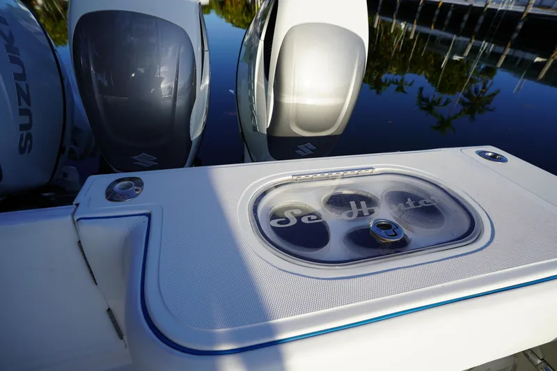 Slide: The Image of 2014 SeaHunter 45 Tournament boat with Suzuki engines, docked on calm water. - 7