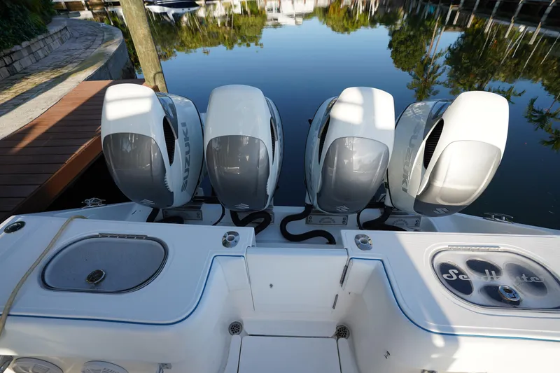 Slide: The Image of 2014 SeaHunter 45 Tournament boat with four Suzuki outboard engines docked by calm water. - 9