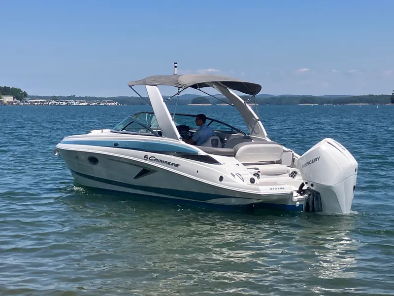 Slide: The Image of 2023 Crownline 270 XSS boat on calm water. - 10