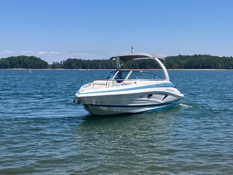 Slide: The Image of 2023 Crownline 270 XSS boat on calm water. - 2