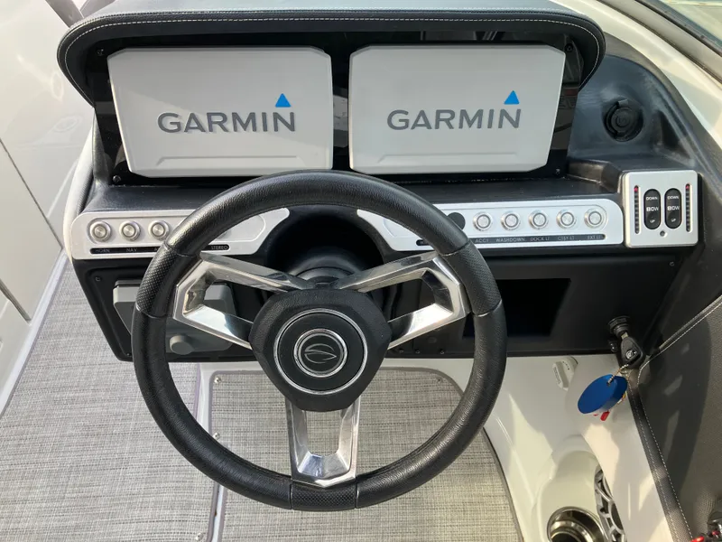 Slide: The Image of Steering wheel and Garmin displays on 2023 Crownline 270 XSS. - 21