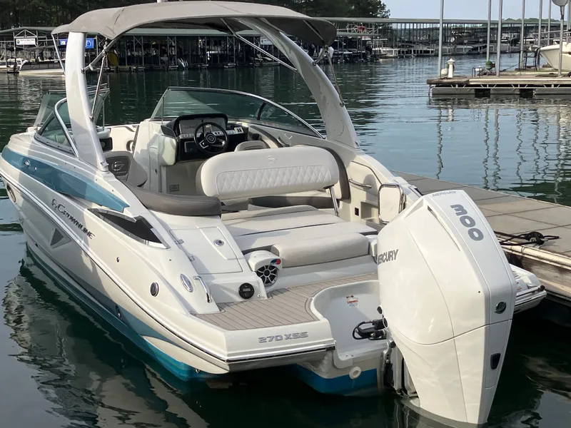 Slide: The Image of 2023 Crownline 270 XSS boat docked with Mercury engine. - 29