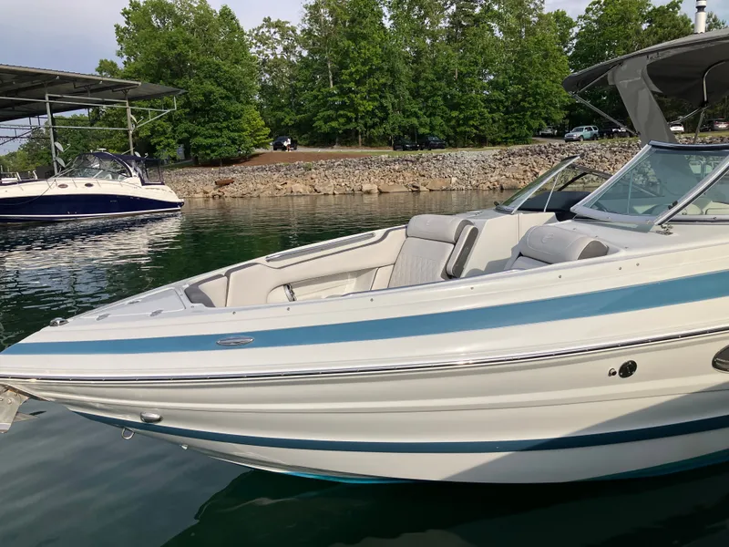 Slide: The Image of 2023 Crownline 270 XSS boat docked by the lakeside. - 30