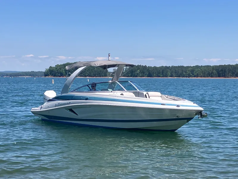 Slide: The Image of 2023 Crownline 270 XSS boat on calm water. - 5
