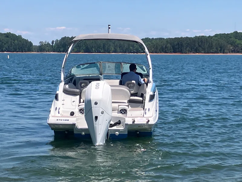 Slide: The Image of 2023 Crownline 270 XSS boat on calm water. - 8