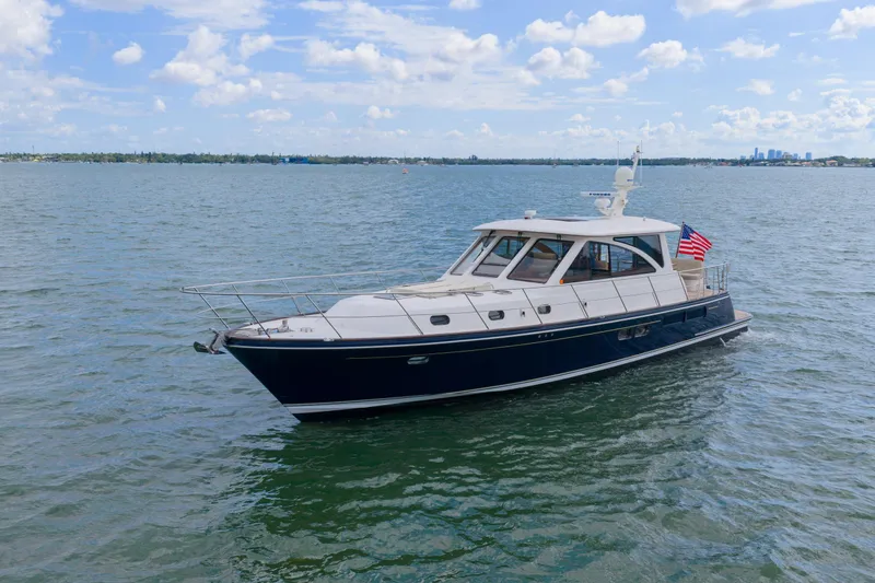 The Image of Elegant 2011 Hunt 52 yacht cruising on a sunny day with American flag. - 0