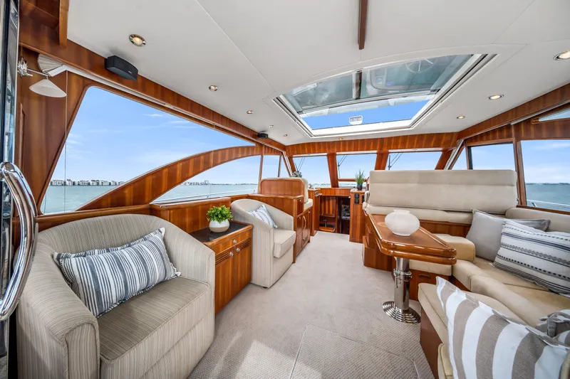 Slide: The Image of Luxurious interior of 2011 Hunt 52 yacht with elegant wood finishes and panoramic windows. - 11