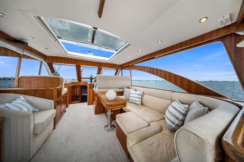 Slide: The Image of Luxurious interior of 2011 Hunt 52 yacht with plush seating and panoramic windows. - 12