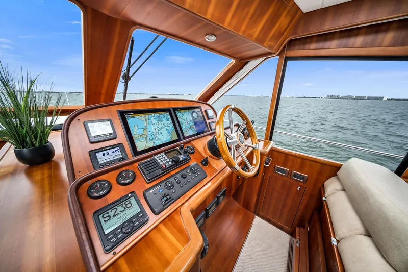 Slide: The Image of Luxurious 2011 Hunt 52 yacht helm with navigation screens and wooden steering wheel. - 13