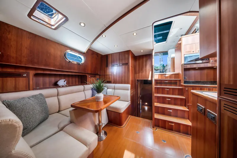 Slide: The Image of Luxurious 2011 Hunt 52 yacht interior with elegant wood finish and plush seating. - 15