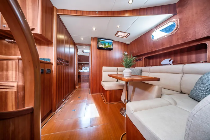 Slide: The Image of Luxurious 2011 Hunt 52 yacht interior with elegant wood finish and comfortable seating. - 16