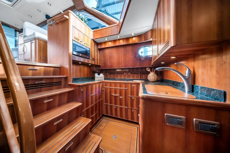 Slide: The Image of Luxurious wooden interior of 2011 Hunt 52 yacht kitchen with modern amenities. - 17