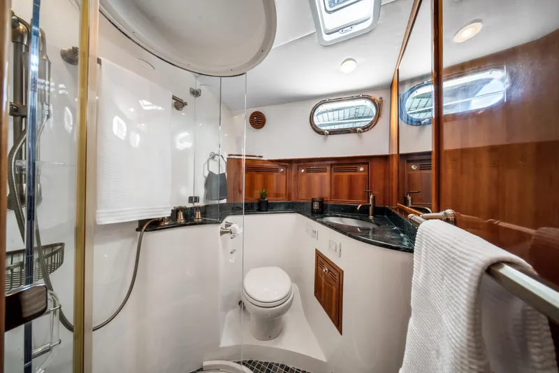 Slide: The Image of Luxurious bathroom in 2011 Hunt 52 yacht with wood accents and modern fixtures. - 19