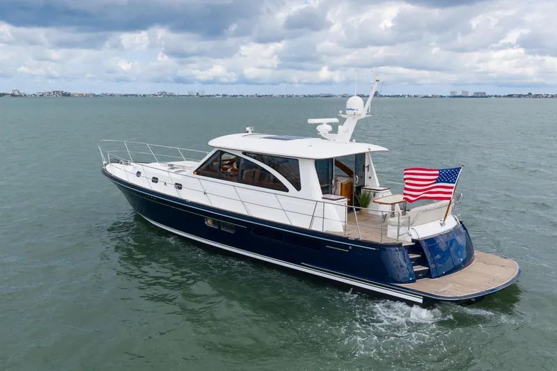 Slide: The Image of Luxurious 2011 Hunt 52 yacht cruising on open water under cloudy skies. - 2