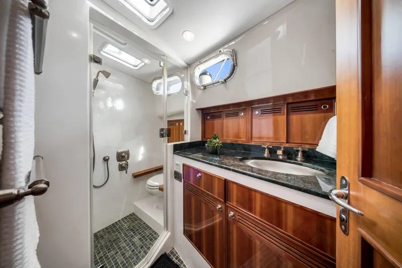 Slide: The Image of Luxurious bathroom in 2011 Hunt 52 yacht with wooden cabinetry and modern fixtures. - 20