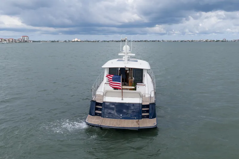 Slide: The Image of 2011 Hunt 52 yacht cruising on open water under cloudy skies. - 3