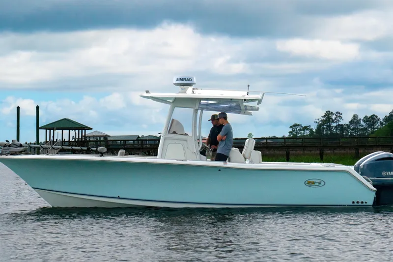 The Image of 2014 Sea Hunt Gamefish 27 boat on water, featuring sleek design and modern equipment. - 1