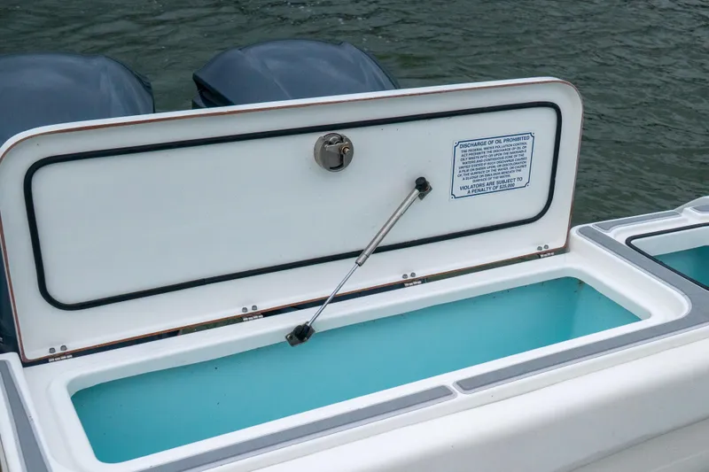 Slide: The Image of Open storage compartment on a 2014 Sea Hunt Gamefish 27 boat, near water. - 11