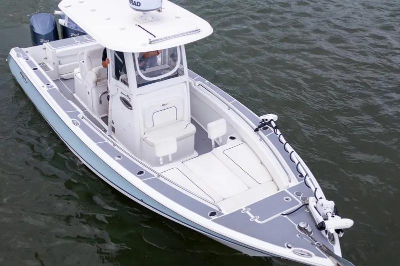 Slide: The Image of 2014 Sea Hunt Gamefish 27 boat on water, featuring sleek design and dual engines. - 14