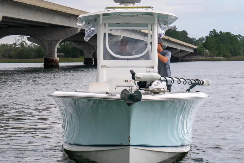 Slide: The Image of 2014 Sea Hunt Gamefish 27 boat on water near a bridge. - 2