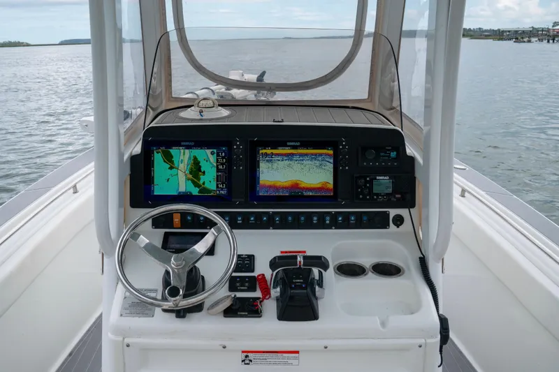Slide: The Image of Helm of 2014 Sea Hunt Gamefish 27 with navigation screens and steering wheel. - 4