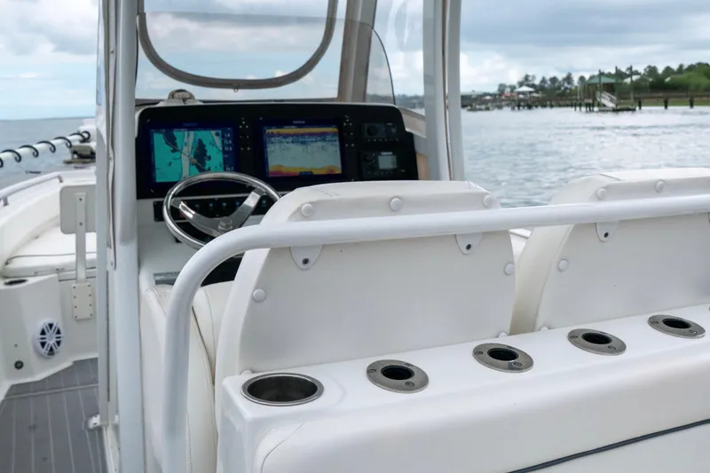 Slide: The Image of 2014 Sea Hunt Gamefish 27 boat interior with navigation screens and seating. - 5