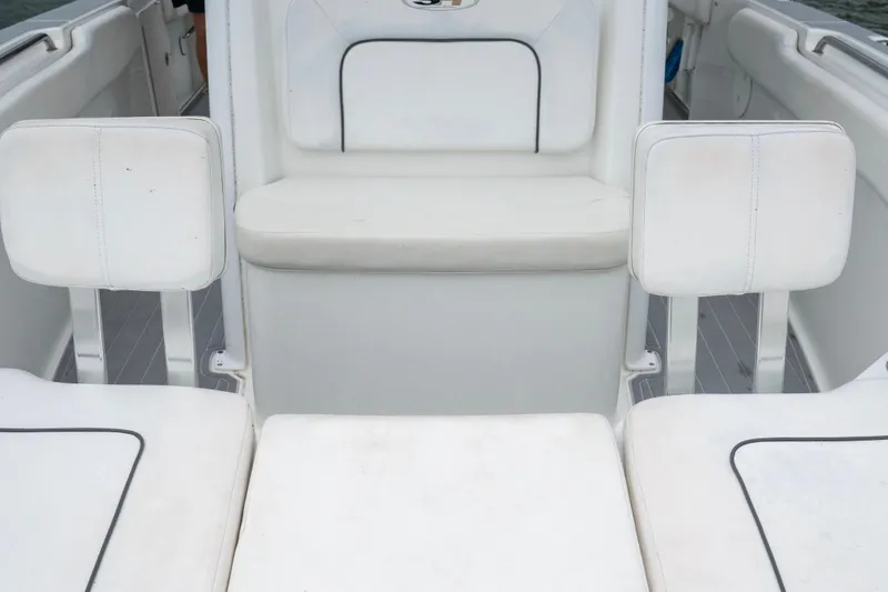 Slide: The Image of Interior seating of a 2014 Sea Hunt Gamefish 27 boat, featuring white cushioned seats. - 9