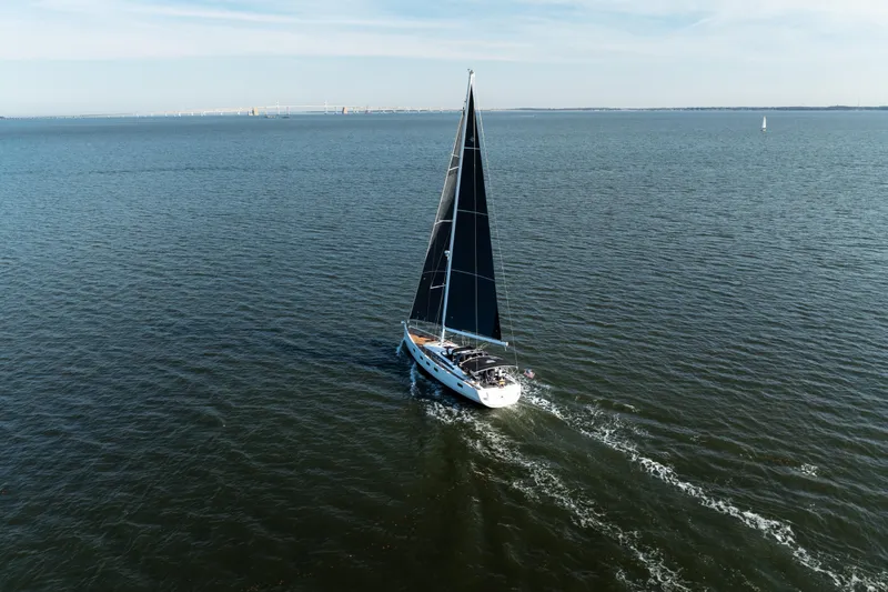 Slide: The Image of Sailing yacht Jeanneau 64, 2016 model, cruising on open water under clear skies. - 10