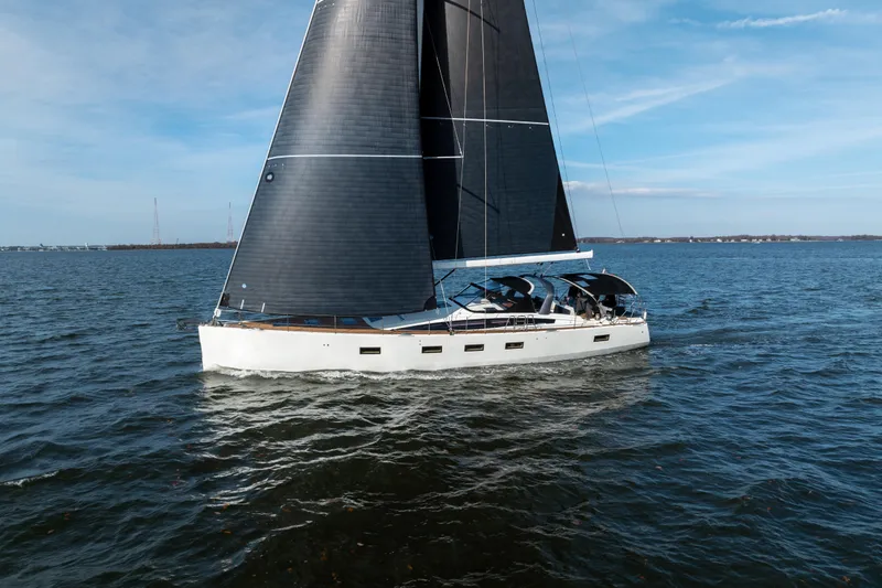 Slide: The Image of 2016 Jeanneau 64 sailing yacht on open water under clear skies. - 3