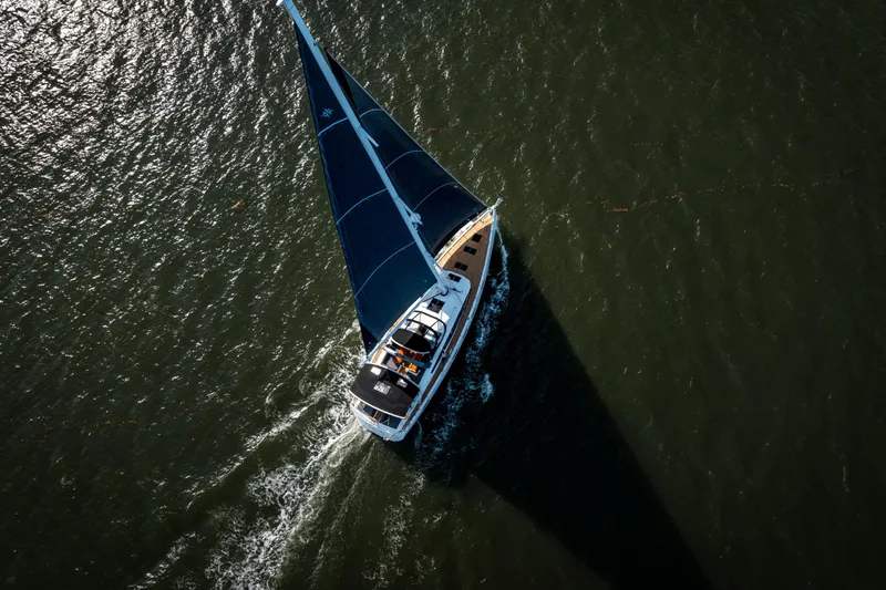 Slide: The Image of Aerial view of 2016 Jeanneau 64 sailboat navigating through open water. - 9