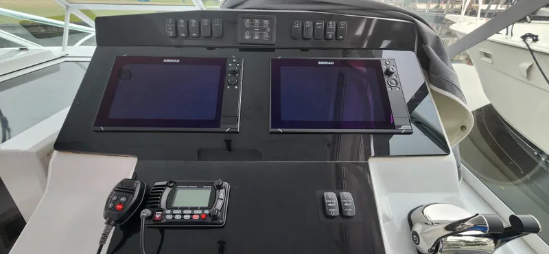 Slide: The Image of Control panel of a 1995 Cabo 35 Express boat with dual Simrad displays. - 14