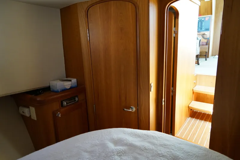 Slide: The Image of Cozy Mainship boat interior with wooden doors and stairs leading to upper deck. - 23