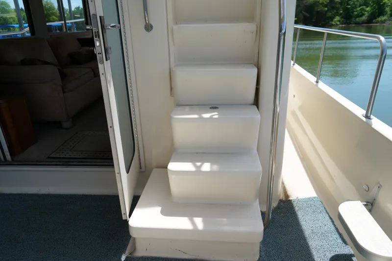 Slide: The Image of Staircase on Mainship boat leading to upper deck, with interior and water view. - 25
