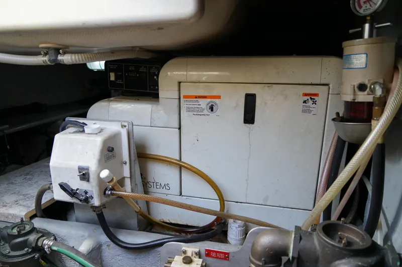 Slide: The Image of Engine room of a Mainship boat featuring mechanical systems and fuel filter components. - 35