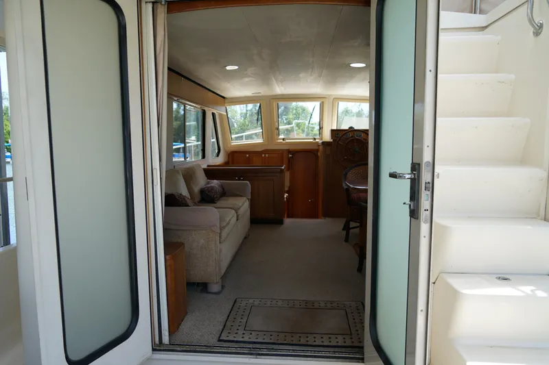 Slide: The Image of Interior view of a Mainship boat with cozy seating and helm. - 9