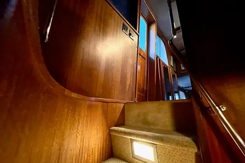 Slide: The Image of Interior staircase of 1976 Hatteras 48 Long Range Cruiser with wooden paneling. - 12