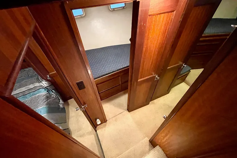 Slide: The Image of Interior of 1976 Hatteras 48 Long Range Cruiser with wood paneling and cozy sleeping quarters. - 13