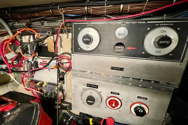 Slide: The Image of Electrical panel of a 1976 Hatteras 48 Long Range Cruiser with wiring and controls. - 18