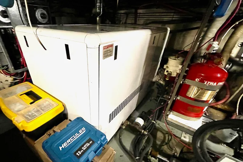 Slide: The Image of Engine room of 1976 Hatteras 48 Long Range Cruiser with equipment and tools. - 21