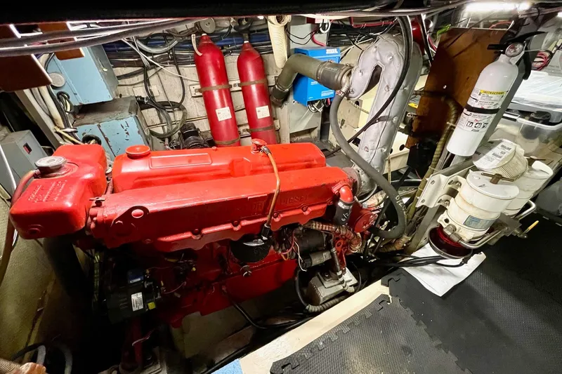 Slide: The Image of Engine room of a 1976 Hatteras 48 Long Range Cruiser with red diesel engine. - 24