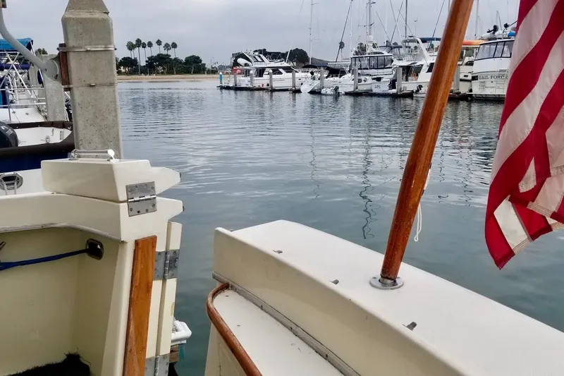 Slide: The Image of 1976 Hatteras 48 Long Range Cruiser docked in a marina with American flag. - 27