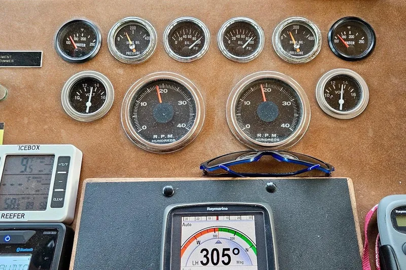 Slide: The Image of Dashboard of a 1976 Hatteras 48 Long Range Cruiser with gauges and navigation equipment. - 29