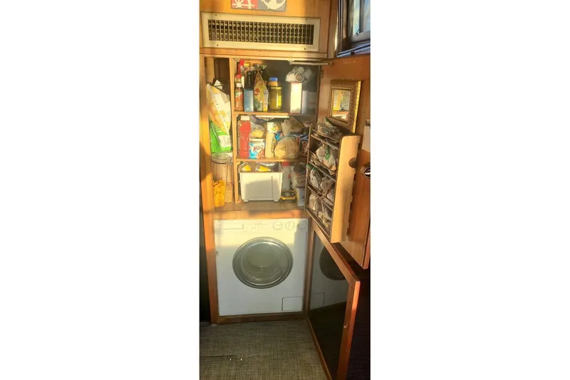 Slide: The Image of Laundry area with storage shelves on a 1976 Hatteras 48 Long Range Cruiser. - 31