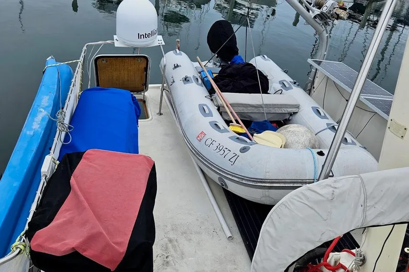 Slide: The Image of 1976 Hatteras 48 Long Range Cruiser with inflatable dinghy on deck. - 33