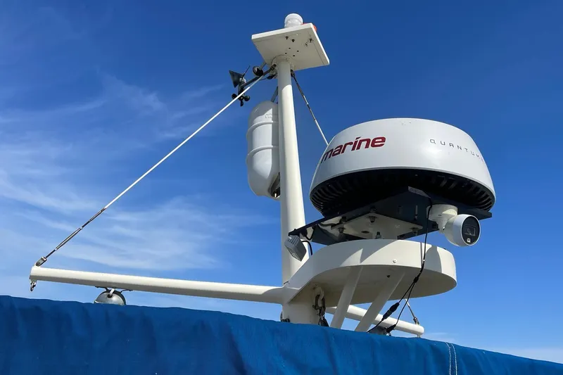 Slide: The Image of Radar equipment on a 1976 Hatteras 48 Long Range Cruiser against a clear blue sky. - 35