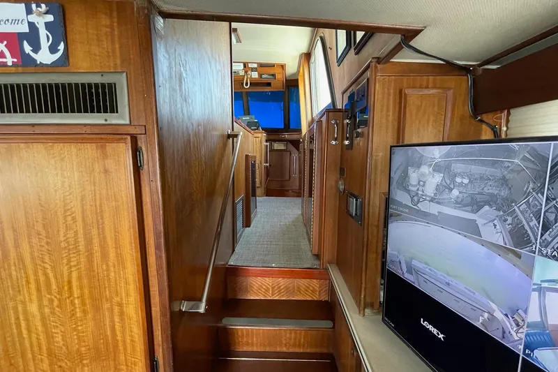 Slide: The Image of Interior of 1976 Hatteras 48 Long Range Cruiser with wood paneling and security monitor. - 43