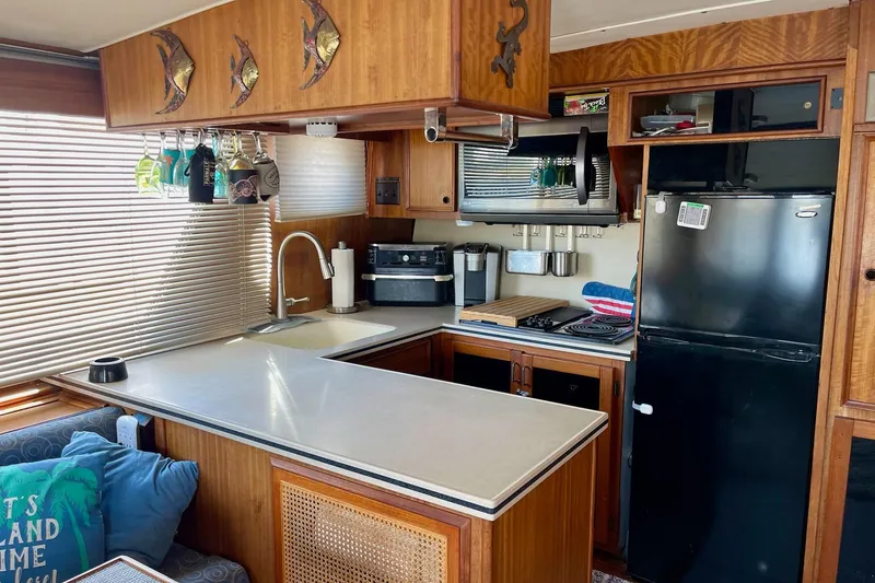 Slide: The Image of 1976 Hatteras 48 Long Range Cruiser kitchen with wood cabinetry and modern appliances. - 44