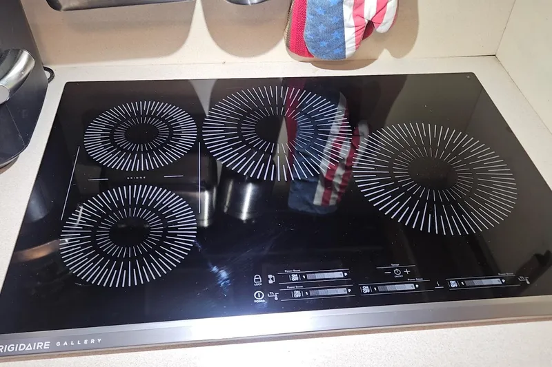 Slide: The Image of Frigidaire Gallery induction cooktop in a 1976 Hatteras 48 Long Range Cruiser kitchen. - 46