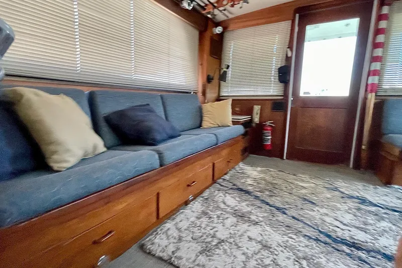Slide: The Image of Interior of 1976 Hatteras 48 Long Range Cruiser with blue seating and wooden accents. - 47