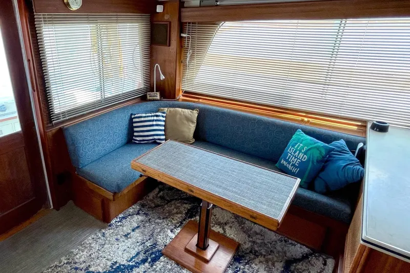 Slide: The Image of Interior of 1976 Hatteras 48 Long Range Cruiser with cozy seating and nautical decor. - 48
